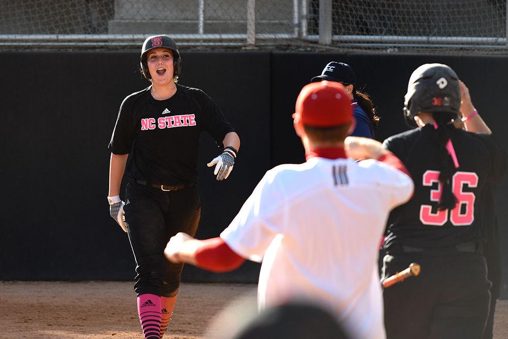 Junior catcher Molly Hutchison struts her way back to the dugout after sliding into home plate for a run during the Wolfpack's first of two games in a double header against Pittsburgh on April 2. Hutchison scored three runs in two at bats and had two RBIs in the 6-5 win at Dail Stadium.