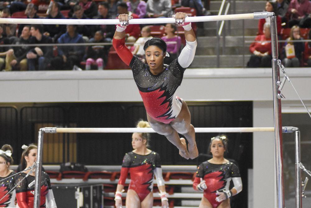 Junior Chelsea Knight maintains her focus while she swings from the uneven bars during her routine. She finished first overall on the uneven bars with a near perfect score of 9.900. UNC Chapel Hill placed first with NC State just behind with a score of 195.625-195.025 at Reynolds Coliseum on Feb. 10.
