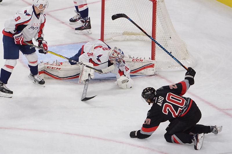 Hurricanes forward Sebastian Aho tumbles to the ice after scoring his first NHL goal in the the Hurricanes game against the Washington Capitals on Saturday. Aho recorded two goals and one assists in the Canes 5-1 victory over the Capitals.