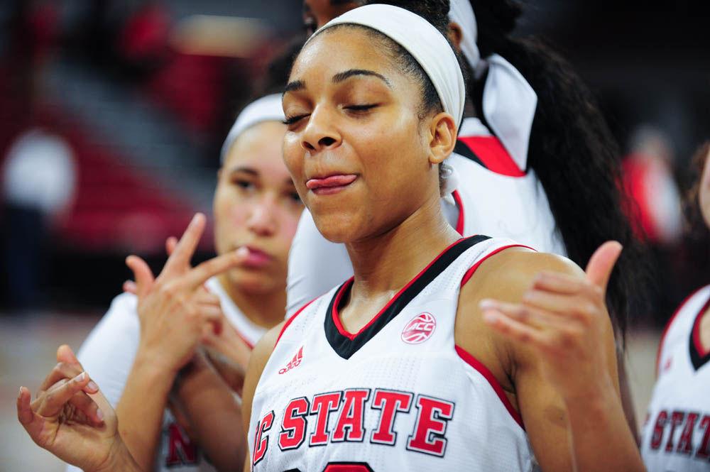 Senior gaurd Dominique Wilson enjoys the crowd as they give the seniors a standing ovation during the 4th quarter at Reynolds Coliseum. Wilson was one of four seniors who were honored at the game on Feb. 23.