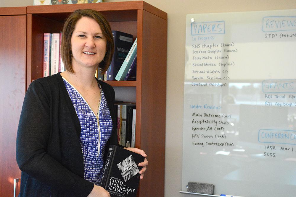 Laura Widman holds a book on Child Adolescent Sexuality on Tuesday. Widman is an assistant professor in the Department of Psychology, currently researching on the understanding and the improvement of sexual health, especially among teenagers. Her research strongly emphasis on the communication skill development on the sexual topics and the prevention on HIV/STD. Widman accomplished many successful research projects, including the publishing of a meta-analysis in health psychology, and many others that are still ongoing. The newest research she is doing is Project HEART (Health Education and Relationship Training). Project HEART is an interactive, web-based sexual health program for teenage girls from ages 15-19. Right now, she is creating a program that provide more participants, including males.