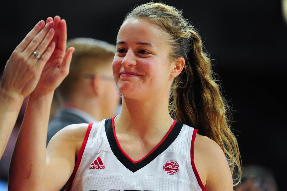 Senior gaurd Ashley Williams smiles as she finishes her last minutes at Reynolds Coliseum. Williams scored 18 points on Feb 23. in the NC State win over UNC. Williams was among four seniors who were honored during their last home game. The Wolfpack recorded a win with a score of 80-60.