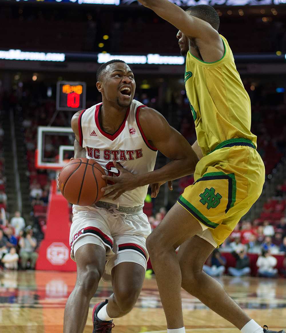 Redshirt-sophomore gaurd Torin Dorn attempts to score a layup but is blocked by a Notre Dame player. Dorn scored only 1 of 4 shots taken during the match. The NC State mens basketball team lost to Notre Dame 72-81 at PNC Arena on Feb. 18.
