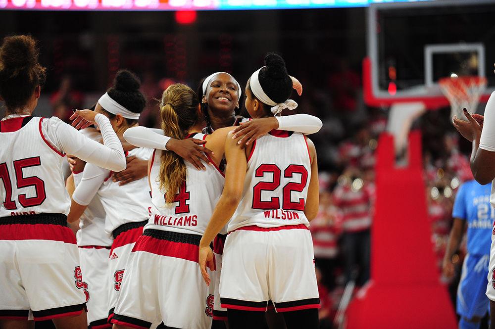 Redshirt freshman guard Kaila Ealey embraces seniors Ashley Williams and Dominique Wilson at Reynolds Coliseum on Thursday. Four NC State seniors were honored during the 20 point win over UNC-Chapel Hill.&#160;