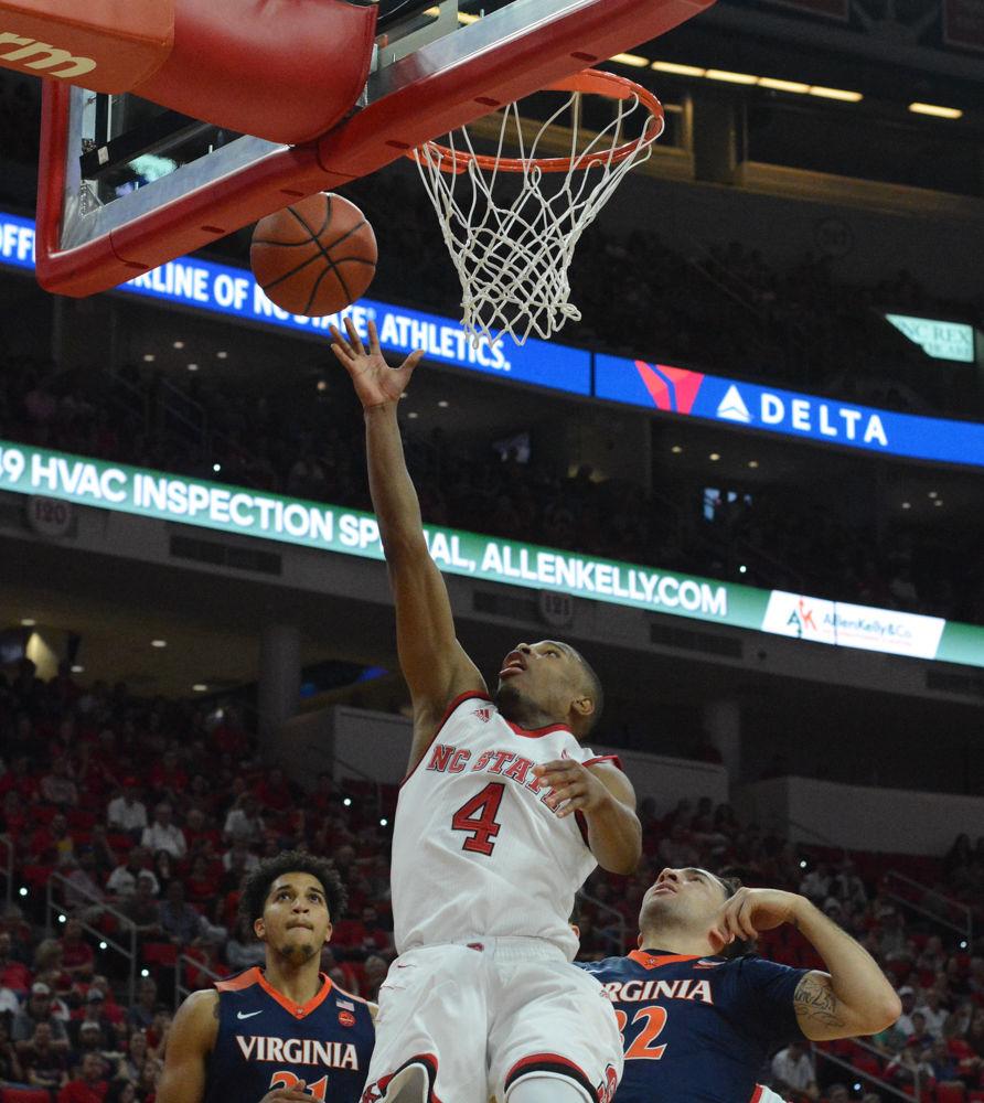 Freshman guard Dennis Smith Jr. tosses up another two pointer against players from Virginia. Overall Smith has led his team with a leading score of points in games this season and this game as well with 13 points. The Wolfpack was defeated 70-55.