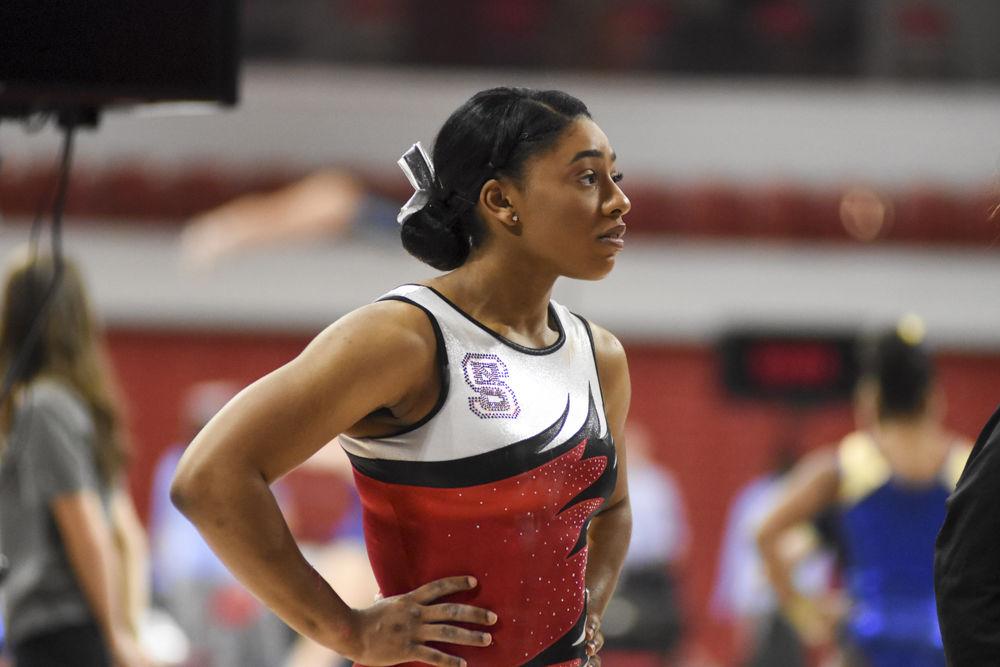 Junior Chelsea Knight watches intently as her teammates perform on the balance beam. She competed in the uneven bars and vault, scoring well in both. The Wolfpack came in second behind UNC Chapel Hill with an overall score of 195.025 at Reynolds Coliseum on Feb .10.