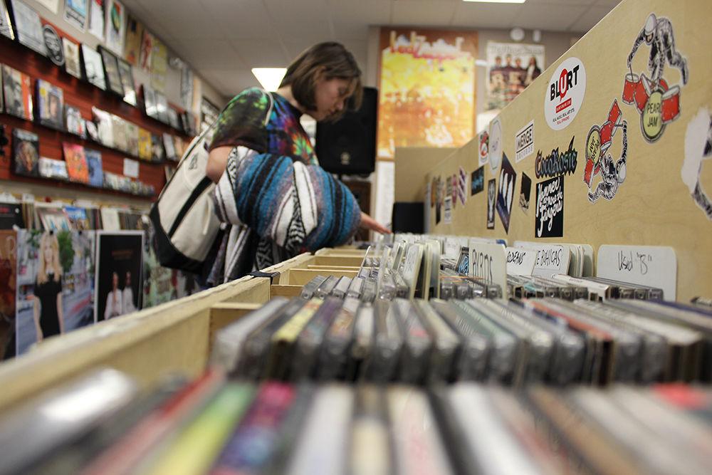 Nora Skinner, a freshman studying marine science, browses in Schoolkids records with her friends on Sunday Feb.19. Skinner said "I liked that the shop had something for everyone, lots older and new music."