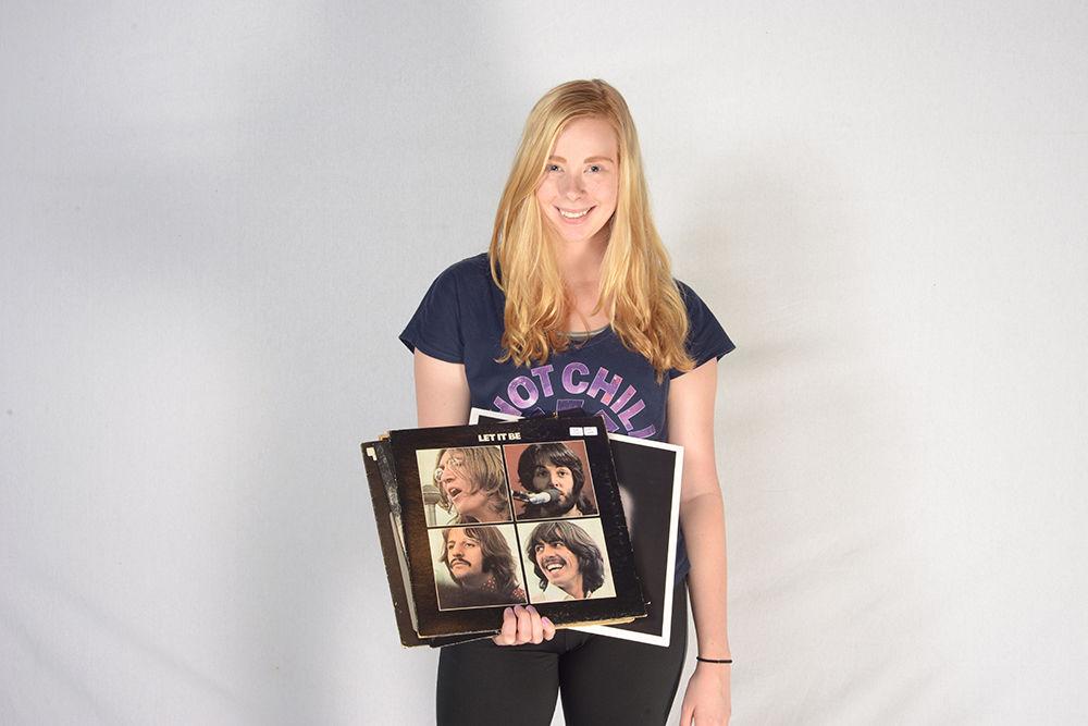 Staff writer Sarah Gallo holds her bounty of fresh record finds from Raleigh's finest shops. Gallo's favorite pick, "Let It Be" by the Beatles, set her back a meager three bucks.