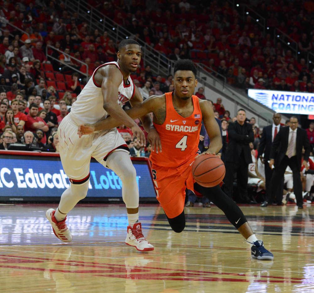 Freshman Dennis Smith Jr. goes after John Gillon of Syracuse. Both players played competitively in the ACC game on Wednesday in PNC Arena, however Syracuse took the win in overtime.
