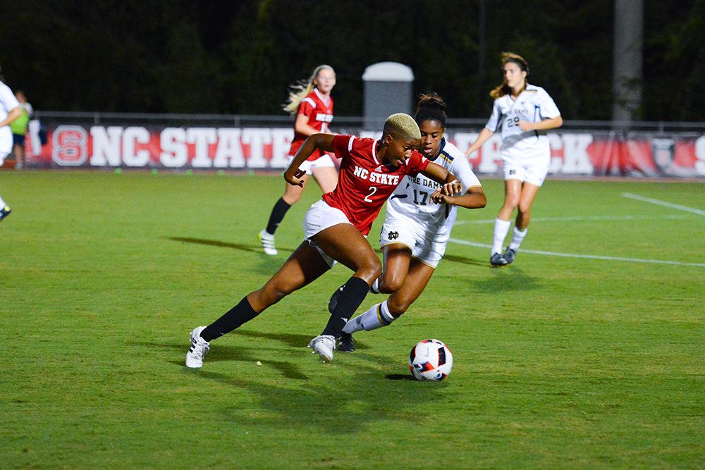 Freshman midfielder Tziarra King sprints will dribbling the ball around a Notre Dame player. King didn't take any shots during the game but played almost the entire game at 86 minutes. The NC State womens soccer team lost to Notre Dame 0-1 at Dail Soccer Stadium.