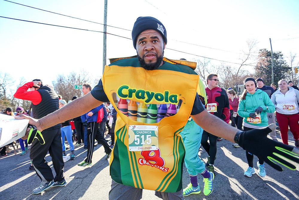 Chadwick Franks, from Raleigh, NC runs by in his Crayola costume. The Krispy Kreme Challenge brought in 6,906 participants on Feb. 4th in Raleigh, NC.