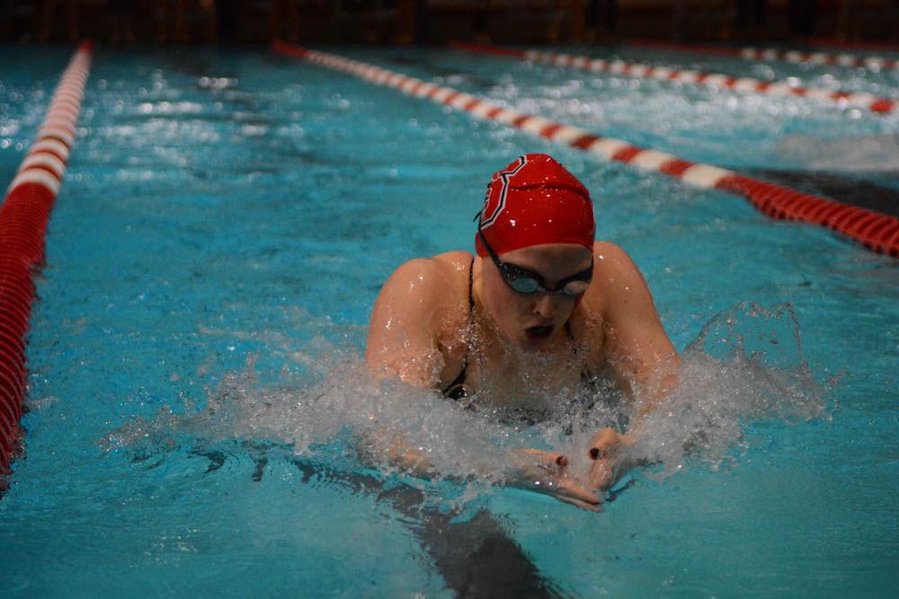 Senior Kayla Brumbaum swims the 100 yards breaststroke against the UNC-Chapel Hill swim team in the Willis R. Casey Aquatic Center on Jan. 27, 2017. In the 100 yard breaststroke event, Brumbaum came in first with the time of 59.79 seconds. The Wolfpack's team won the game against the UNC Tar Heels in 26 of 32 events.