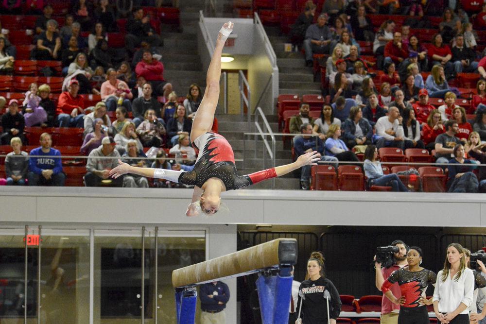 Freshman gymnast Melissa Brooker backflips on the balance beam in a quad meet against UNC-Chapel Hill, William &amp; Mary, and Pittsburgh in the Reynolds Coliseum on Feb. 10. Brooker accomplished her career best on the floor with a score of 9.775. The meet ended with Wolfpack coming in second, with a score of 195.025, behind UNC-Chapel Hill, 195.625 and ahead of Pittsburgh with 194.075 points.