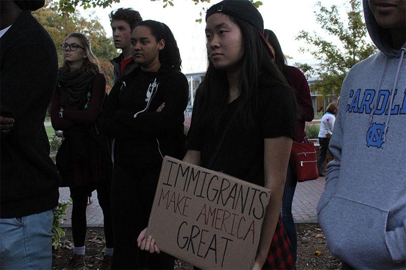 Jasmine Wang, a junior studying engineering, displays protest sign during a Demonstration of Post-Election Solidarity. The rally served as an outlet for those who were upset by the results of the presidential election. The demonstration took place in Wolf Plaza on Friday.