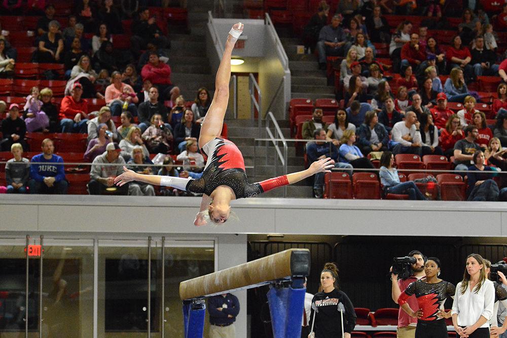 Freshman gymnast Melissa Brooker backflips on the balance beam on a quad meet against UNC-Chapel Hill, William &amp; Mary, and Pittsburgh in the Reynolds Coliseum on Feb. 10, 2017. Brooker accomplish her career best on the floor with the score of 9.775. The meet ended with Wolfpack coming in second, with the score 195.025, behind UNC-Chapel Hill, 195.625 and ahead of Pittsburgh, 194.075, and William &amp; Mary, 193.025.