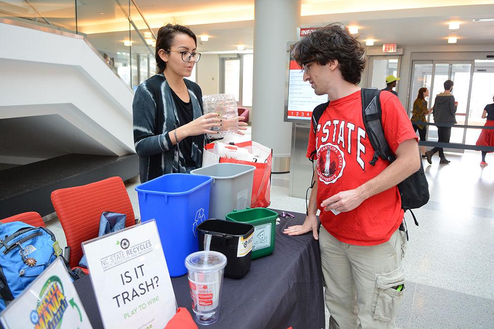 Kyra Levau, a sophomore studying environmental science, explains to Jeffrey Friedler, a senior studying business administration, about how to properly dispose of clamshells in the lobby of Talley Student Union Wednesday. Levau and other representatives of the Office of Waste Reduction &amp; Recycling offered students the opportunity to play a game of determining whether certain objects were to be thrown away or recycled in order to earn prizes. "It was very informative" Friedler said. "For example, I learned that plastic clamshells have their own recycling bin on campus!" According to Levau, the purpose of the game was to promote Recycle Mania, a tournament in which schools across the nation compete to see who can recycle the most as well as to make people aware of what they can and cannot recycle on campus.