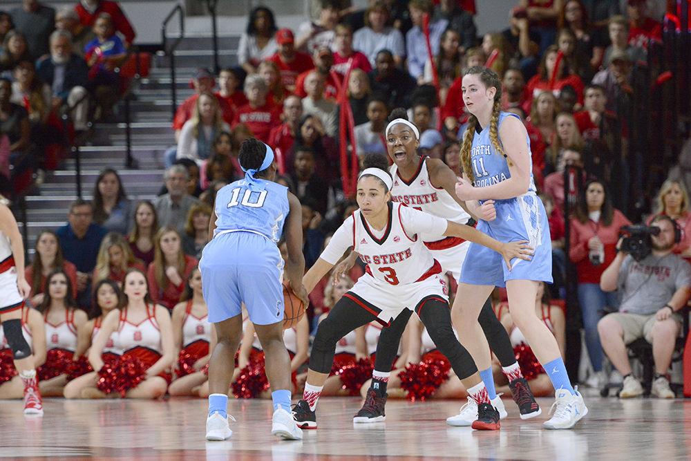Senior guard Miah Spencer defends a UNC-Chapel Hill player during the game in Reynolds Coliseum on Feb. 23. Spencer had a total of four rebounds and nine assists throughout the game against UNC-Chapel Hill. The Wolfpack defeated the Tar Heels with a score of 80-60.