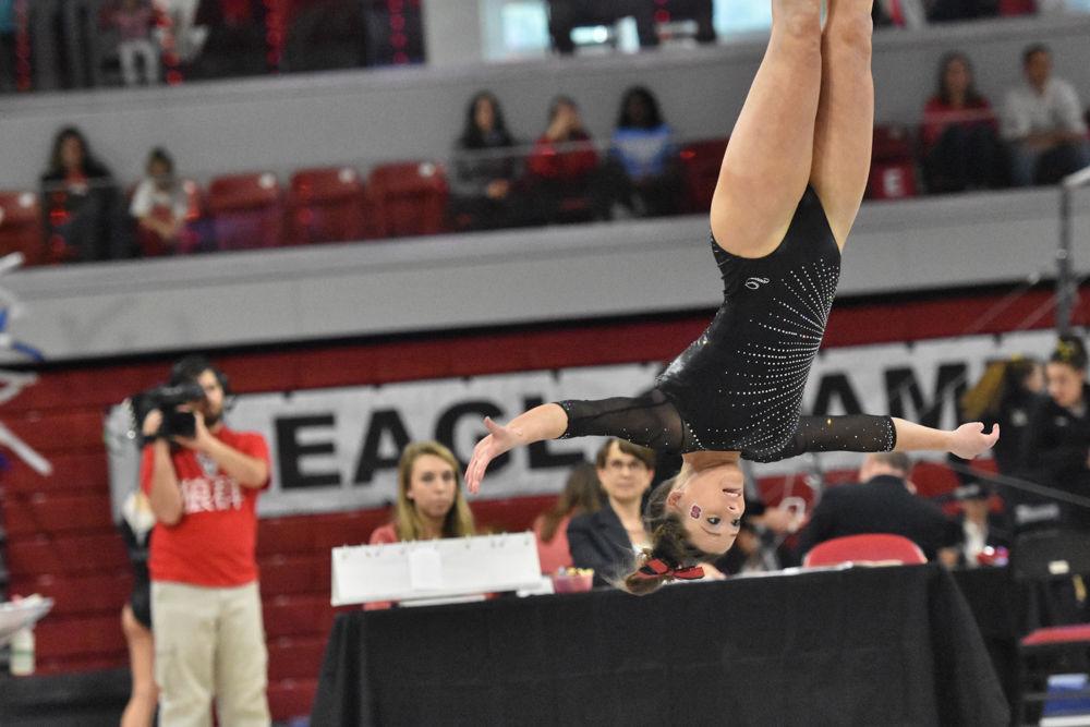 Alexa Phillips, a sophomore in exploratory studies, keeps her form while she flies through the air during the 2017 EAGL gymnastics championship in Reynolds Coliseum on March 18. Phillips scored a 9.800 for her routine helping the pack clinch third place overall for the championship.