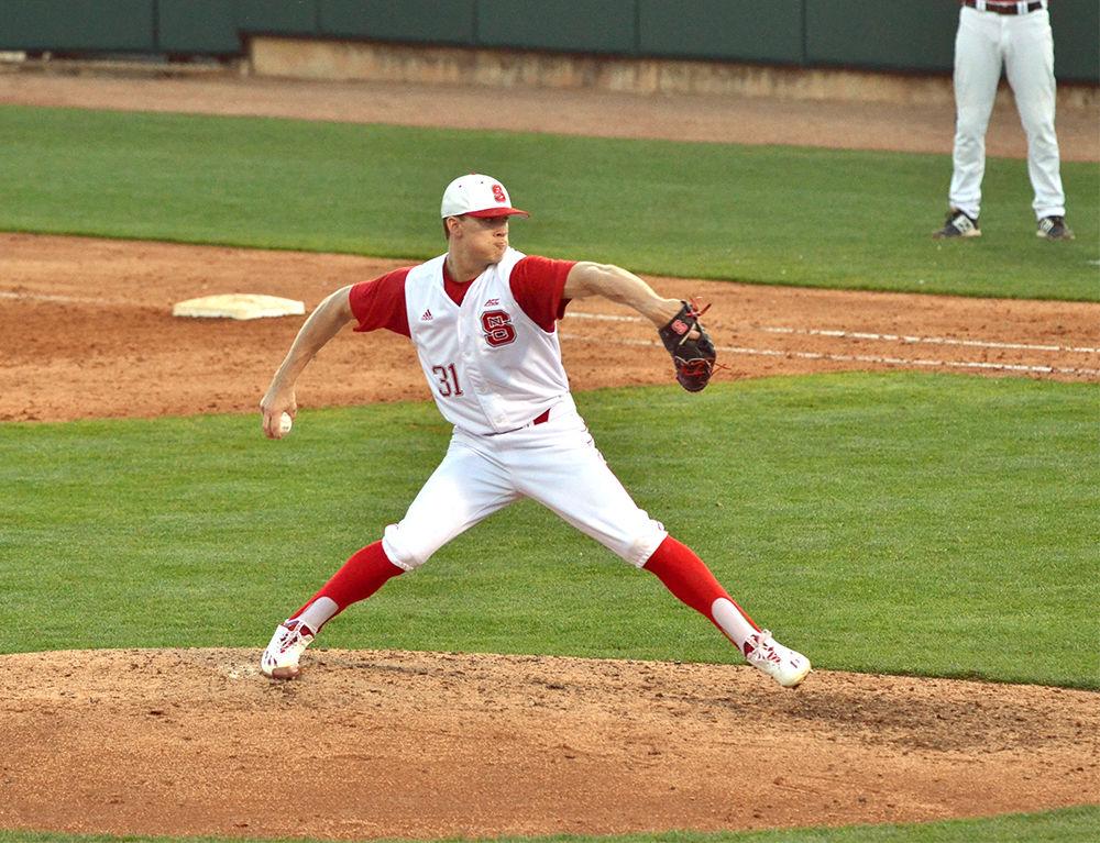 Junior pitcher Evan Brabrand lobs a ball at Austin Peay during their game on Friday in Doak Field. The Wolfpack beat the Governors 9-3, bringing their record to 3-1.