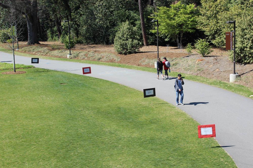 Signs from the "Dear White People" demonstration line the sidewalk at Stafford Commons on Thursday. The event was sponsored by UAB Films and was intended to spark discussion about common racial stereotypes.