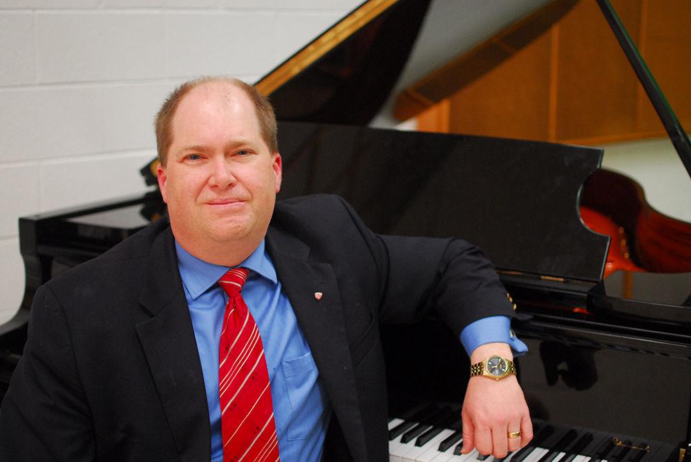 The head of the Music Department, Daniel Monek, sits in front of a grand piano in Price Music Center on Friday. Monek accepted his position at NC State in April of 2016 and has served as the department head and filled in as a choral director in the absence of Nathan Leaf. Monek is the former department chairman of Marietta College, where he also served as a professor of choral and vocal music.