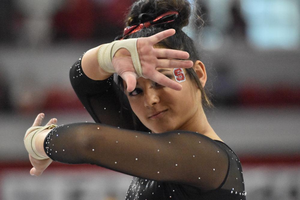 Drew Grantham, a freshman studying elementary education, is in position to begin her floor routine during the 2017 EAGL gymnastics championship in Reynolds Coliseum on March 18. Grantham helped the pack take third place with a score of 9.850 for her floor routine.
