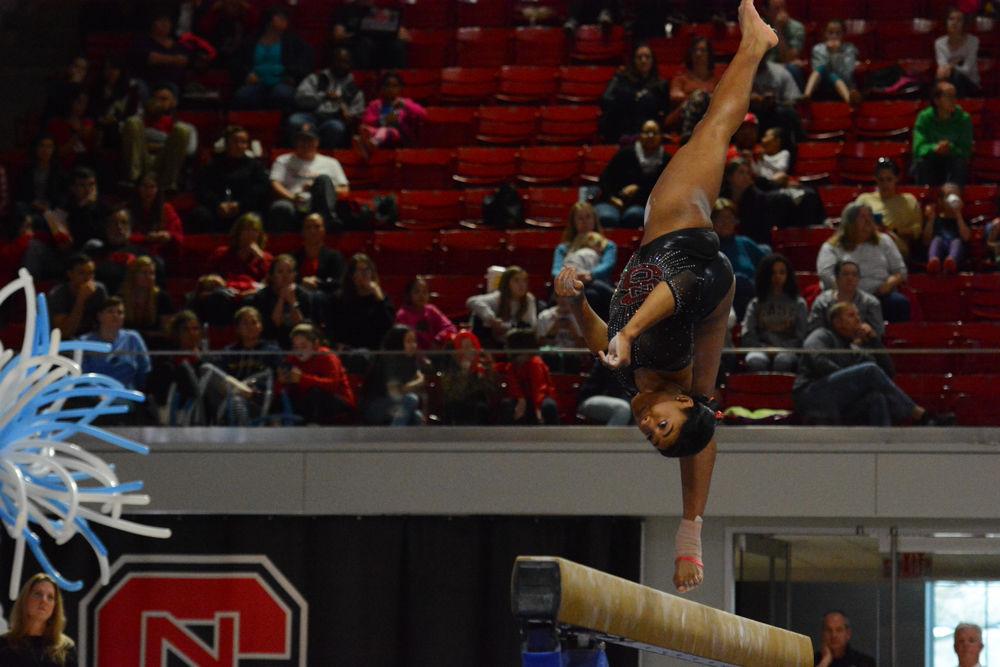Junior gymnast Chelsea Knight flips into the air, showing her flexibility and great balance at a the balance beam event at Reynolds Coliseum on March 18, 2017. Knight receives 9.775 in the vault event, 9.750 in the bars event, 9.775 in the beam event, and 9.875 in the floor event which she won 2nd place in. She also won 3rd place with her all around results of 39.175. The Wolfpack won 3rd place with the score of 194.875 in the meet with George Washington University, University of New Hampshire,&#160;UNC Chapel Hill, University of Pittsburgh, and Towson University.