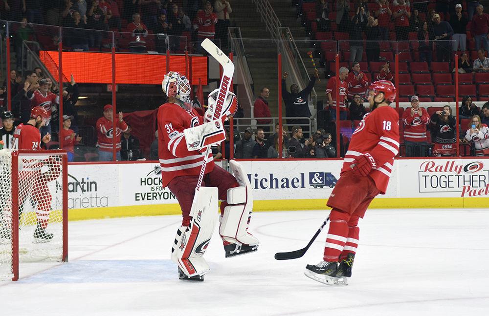 Hurricanes goalie Eddie Lack and forward Jay McClement celebrate the team's 3-0 victory over the Senators on Friday in PNC Arena. Lack recorded his first shutout of the season with 34 saves.