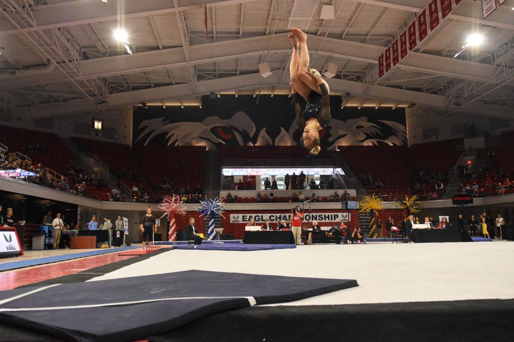 Melissa Brooker, a freshman in exploratory studies, keeps her form during a backflip at the 2017 EAGL gymnastics championship in Reynolds Coliseum on March 18. Brooker came in fourth for her uneven bar routine.