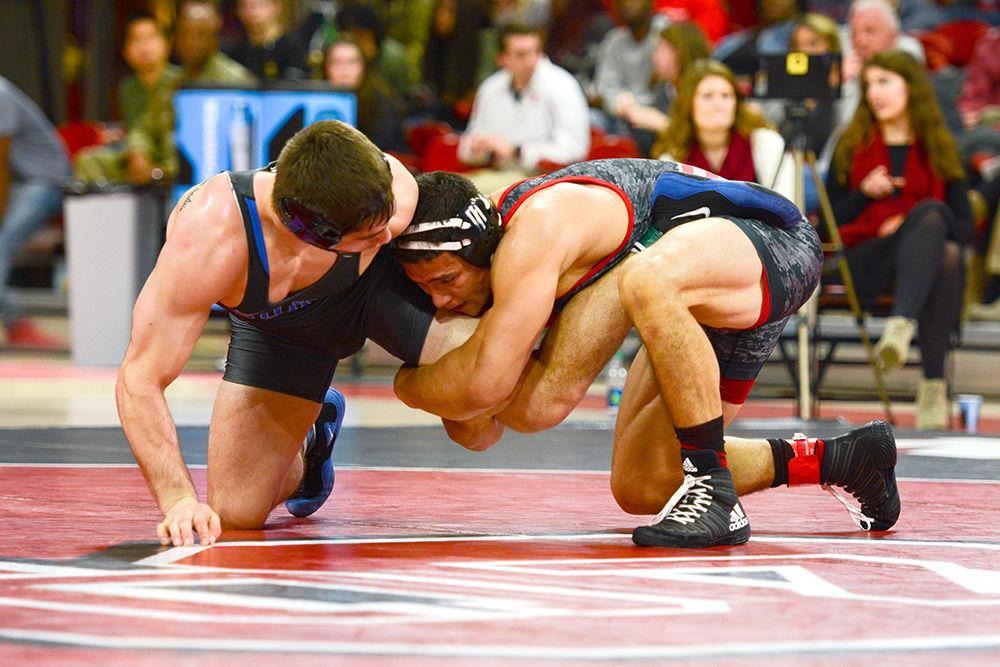 Redshirt junior Michael Macchiavello holds the leg of a Duke wrestler. The NC State wrestling team beat Duke 34-6 in the ACC opener at Reynolds Coliseum on Jan. 11.