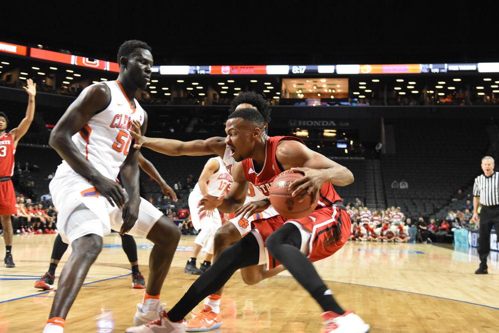 Redshirt sophomore guard Torin Dorn charged a Clemson player on his way to the basket on March 7 during the first round of the ACC Tournament. Dorn scored 7 points, but the Pack was defeated, 75-61.
