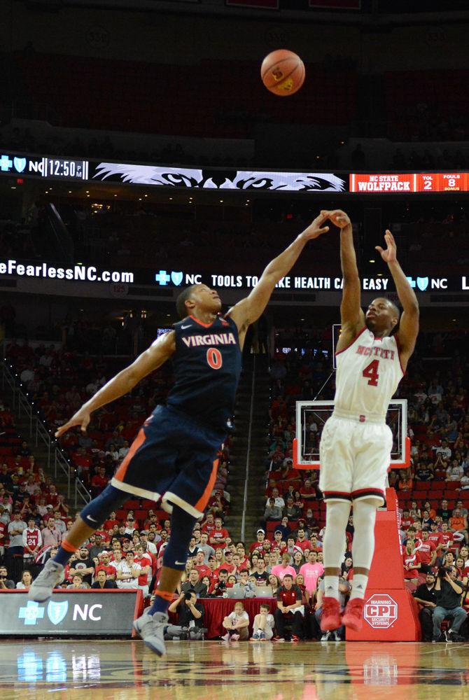Freshman guard Dennis Smith Jr. goes for three points against a player from Virginia. Smith led the Wolfpack in scoring at the game on Saturday in PNC Arena however the team fell to UVA with a final score of 70-55.
