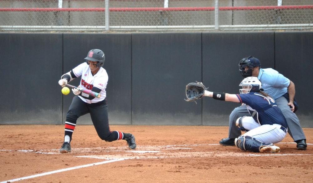Cheyenne Balzer bunts the ball against the University of Virginia in Dail Stadium on Friday, Mar. 17, 2017. Balzer plays the first base and catcher positions.