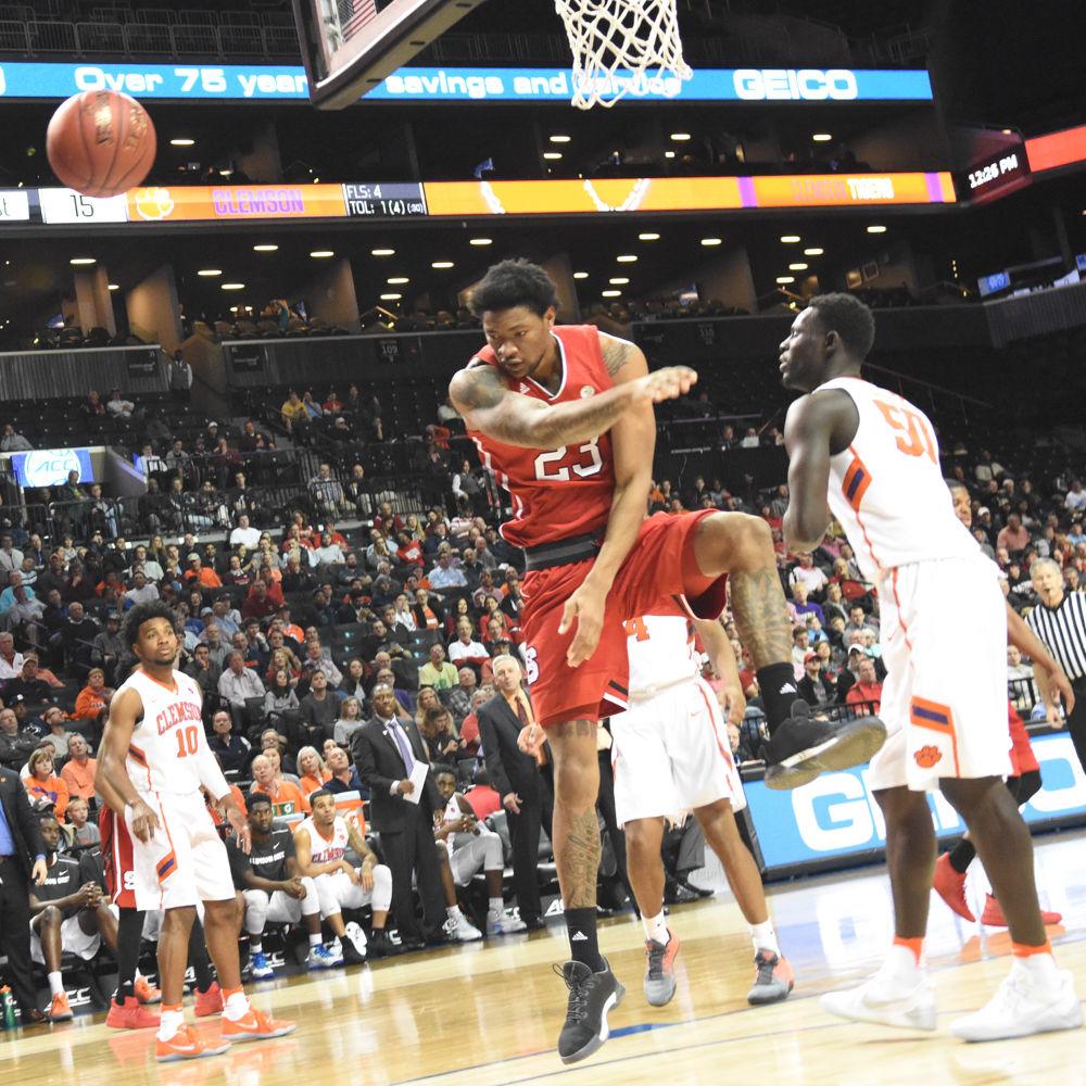 Ted Kapita, a freshman forward, swats the ball away from Clemson in Barclays Center on March 7. Kapita had four rebounds during the game, but the Pack was defeated by Clemson, 75-61.