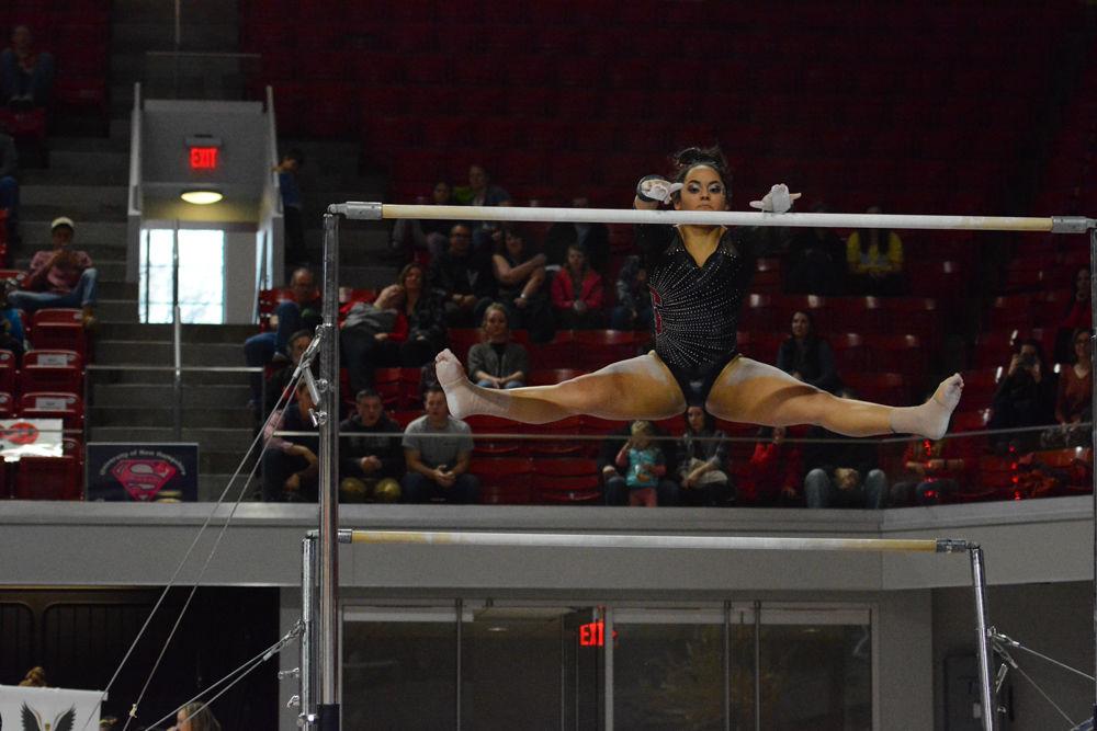 Freshman gymnast Drew Grantham performs a split in the air at the uneven bars event in the Reynolds Coliseum on March 18, 2017. Grantham receives 9.775 in the vault event, 9.525 in the bars event, 9.825 in the beam event, and 9.85 in the floor event which she won 3rd place. The Wolfpack won 3rd place with the score of 194.875 in the meet with George Washington University, University of New Hampshire, UNC Chapel Hill, University of Pittsburgh, and Towson University.