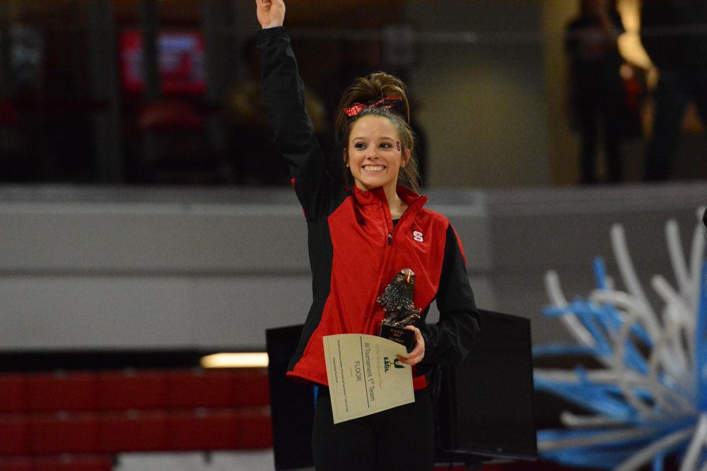 Sophomore gymnast Paris Phillips raises her hand to celebrate that she won first place on the Floor Exercise event as a representative of NC State at Reynolds Coliseum on March 18, 2017. She receives 9.75 on the vault event and 9.9 on the floor event. NC State won third place with the score of 194.875 in the meet with George Washington University, University of New Hampshire,&#160;UNC Chapel Hill, University of Pittsburgh, and Towson University.