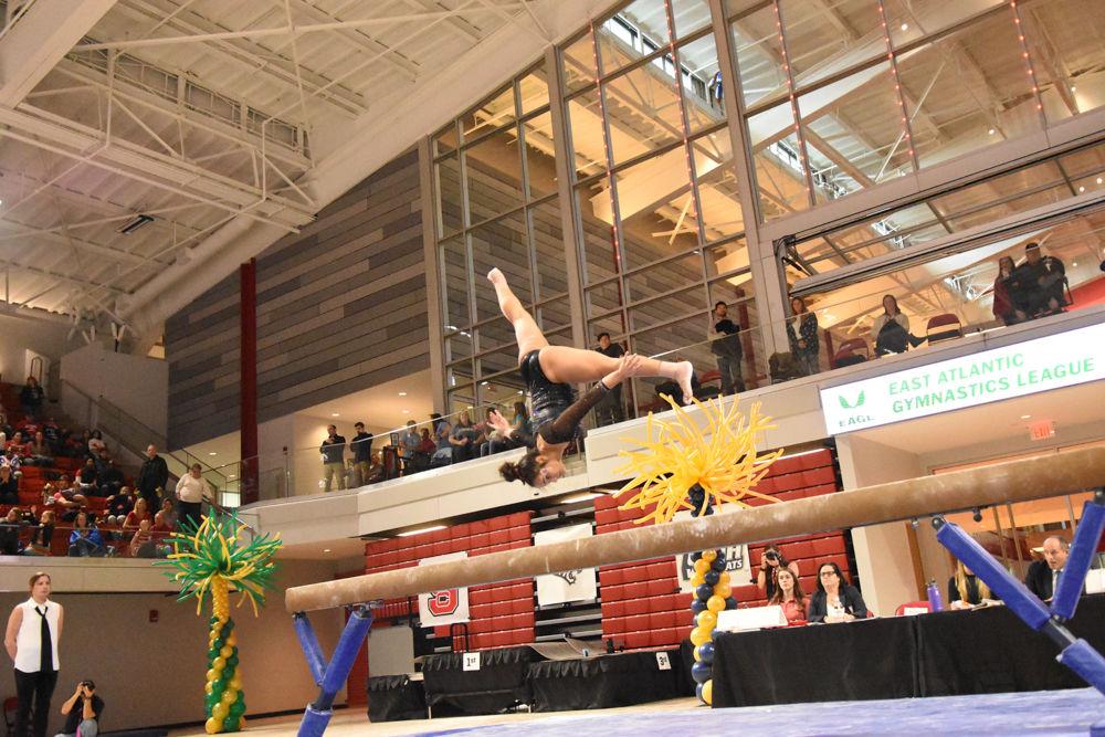 Drew Grantham, a freshman studying elementary education, flips on the balance beam during the 2017 EAGL gymnastics championship in Reynolds Coliseum on March 18. Grantham placed third in the floor event with a 9.850. The Wolfpack came in third place.
