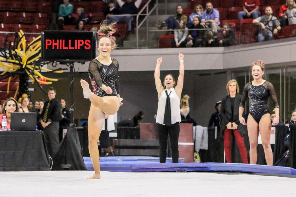 Sophomore Paris Phillips sticks her final pass on floor and finishes off her routine. Phillips came away with a team high 9.900 during the EAGL Conference Championship on March 18th in Reynolds Coliseum. NC State finished third in the conference with at 194.875.