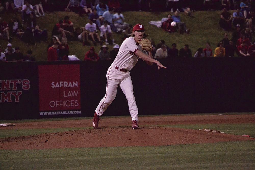 Senior Pitcher Joe O'Donnell attempts to tag out a Louisville player on Doak Field on Friday. The Wolfpack beat the Cardinals, 3-1, for its 13th win this season.