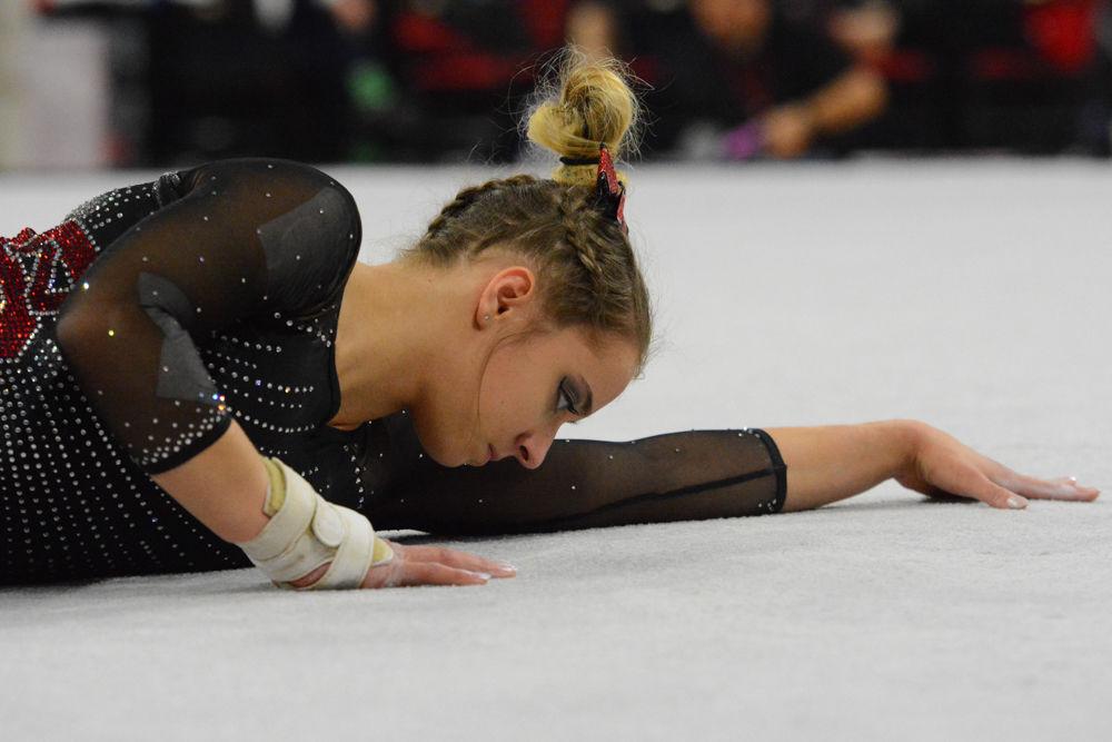 Freshman gymnast Melissa Brooker poses in the beginning of her performance on the floor event at the Reynolds Coliseum on March 18, 2017. Brooker receives 9.8 on the bars event that gave her fourth place, and 9.725 on the floor event. The Wolfpack won 3rd place with the score of 194.875 in the meet with GW University, UNH, UNC Chapel Hill, University of Pittsburgh, and Towson University.