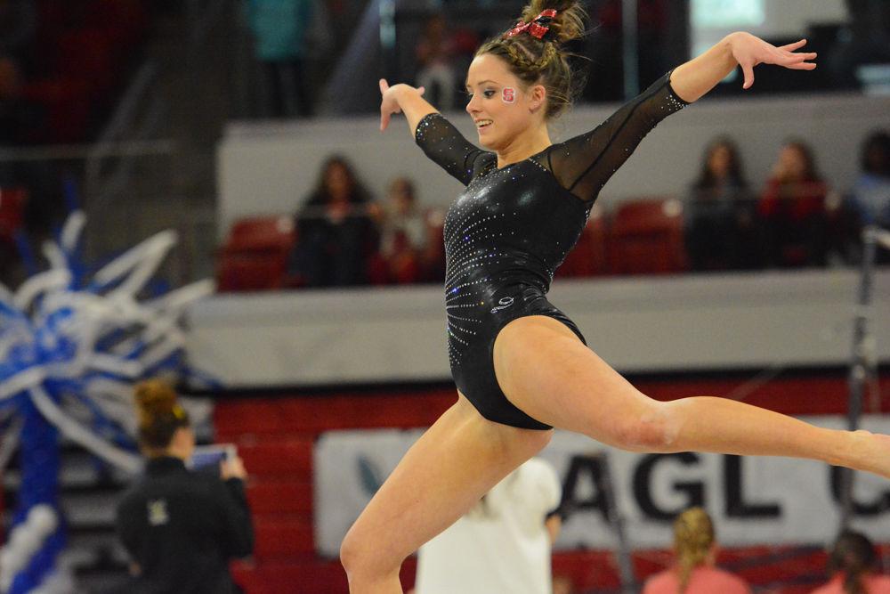 Sophomore gymnast Alexa Phillips leaps into the air in her performance on the floor event at Reynolds Coliseum on March 18, 2017. Phillips receives 9.775 on the vault event, 9.200 on the bars event, 9.675 on the beam event, and 9.8 on the floor event. The Wolfpack won 3rd place with the score of 194.875 in the meet with George Washington University, University of New Hampshire,&#160;UNC Chapel Hill, University of Pittsburgh, and Towson University.