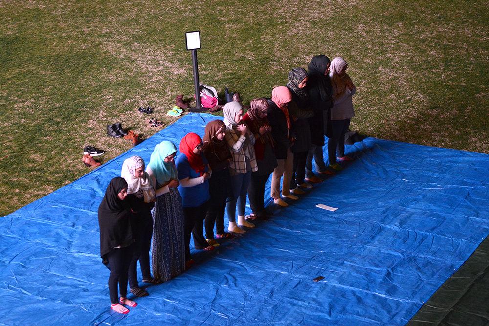 Midway through the United Not Divided Rally held on Stafford Commons on Feb. 20, students of the Muslim faith complete their prayer ritual.&#160; Others in the crowd were encouraged to observe the students' practices. The United Not Divided Rally was held to show solidarity to Muslim students, immigrants, international students, undocumented individuals and all others marginalized by current events.