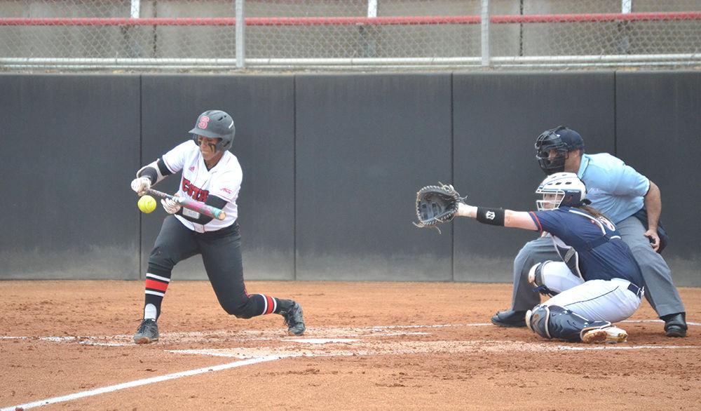 Cheyenne Balzer bunts the ball against the University of Virginia in Dail Stadium on Friday, Mar. 17, 2017. Balzer plays the first base and catcher positions.