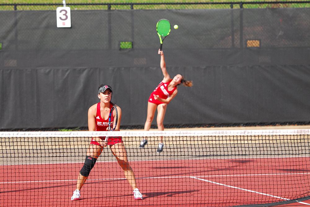 Sophomore teammates Claudia Wiktorin (front) and Bianca Moldovan (back) serve a ball against opponents from Clemson University's tennis team in a their match in J.W. Isenhour Tennis Center on Fri. Mar. 31st, 2017. The duo prevailed against opponents Sydney Riley and Constanza Gorches from Clemson, winning their double's match 6-4. N.C. State's Tennis team also won against the Clemson Tigers 6-1.
