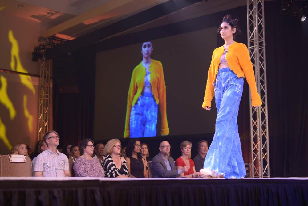 Dipali Aphale, a senior studying industrial design, models a piece from Cristina Wright's collection "Retrospect" during Art2Wear on Friday in Talley Ballroom. Wright, who is a senior studying art and design, drew inspiration from the denim and bright orange colors seen on construction sites.
