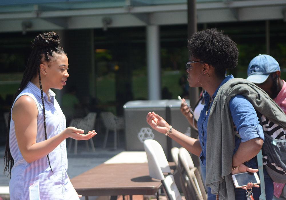 Jessica Stubbs, a junior studying sports management, talks with Zakiya Covington, a sophomore studying science, technology and society, about the important of Denim Day. Denim Day was held on Wednesday in honor of the Italian Supreme Court case that was dismissed because the woman was wearing jeans that were too tight, implying consent. The Women's Center hosted a tabling event on Stafford Commons to raise awareness to combat sexual assault.&#160;