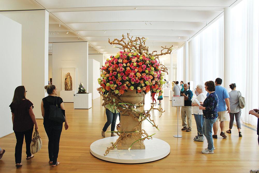 Museum-goers admire a floral arrangement at the &#8220;Art in Bloom&#8221; event at the North Carolina Museum of Art. &#8220;Art in Bloom&#8221; gathered renowned floral designers to create arrangements inspired by the museum's permanent collection. The event ran from Thursday to Sunday.