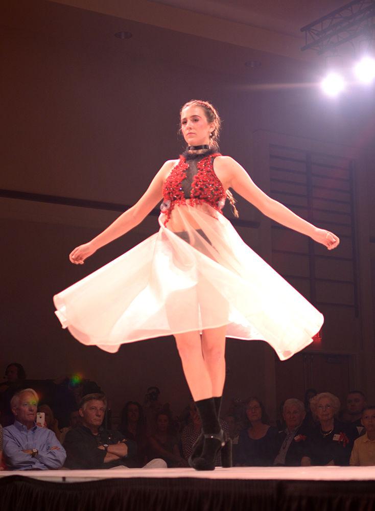 Adrienne Hooper, a senior studying accounting, twirls at the end of the runway during Art2Wear on Friday in Talley Ballroom. The dress was part of senior art and design student Carly Owens' collection "Haunt," which featured intricate hand embroidery and sequins.