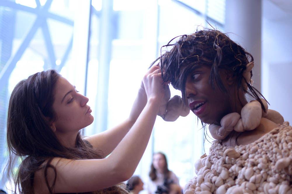 Jeanna Young, a senior studying art and design, puts the finishing touches on one of her models before the Art2Wear dress rehearsal on Friday. Young's collection, titled "Delusions of Identity," intended to "show a metamorphosis of vulnerability upon the human form."