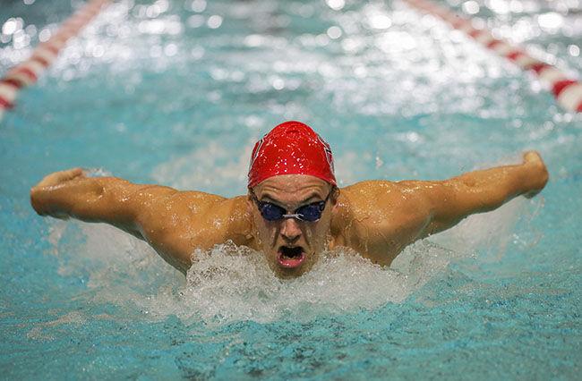 Sophomore Soren Dahl bursts through the water during a butterfly stroke at the Red, White, and Black scrimmage. The scrimmage took place Friday, Sept. 26th.